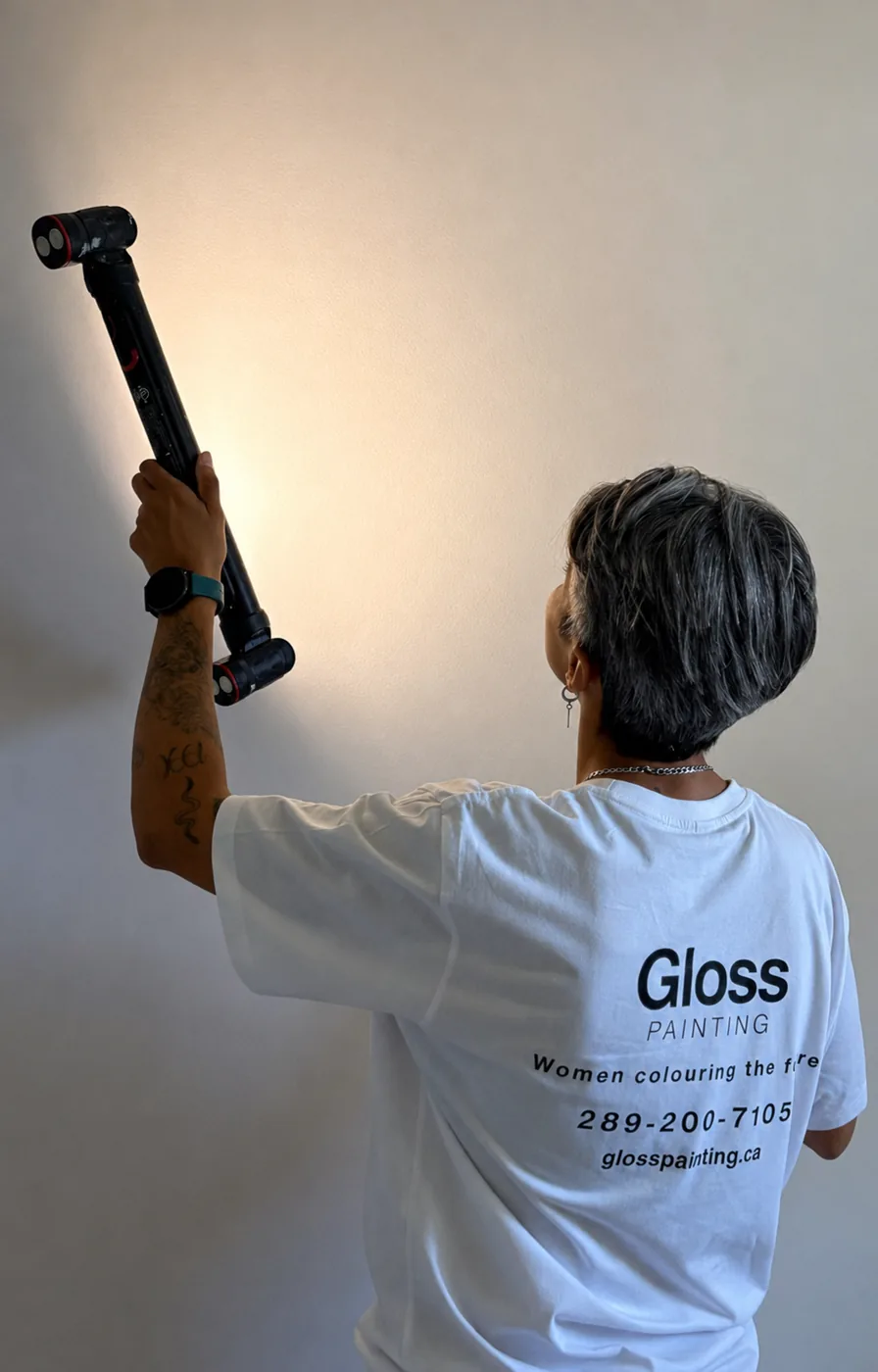 Mika inspecting a wall during an in-home consultation